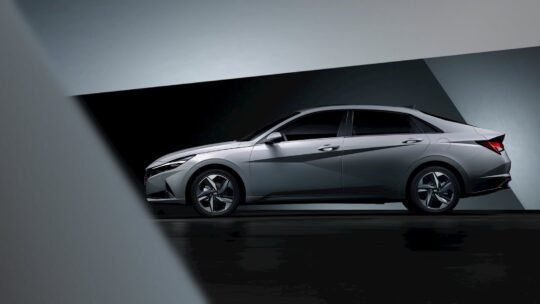 Modern Hyundai sedan showcased in a dark studio environment.