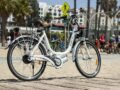 Electric bike parked on a sunny beach in Los Angeles, perfect for city exploration.