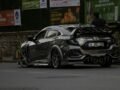 A sleek, customized Honda Civic car on city streets with urban backdrop.