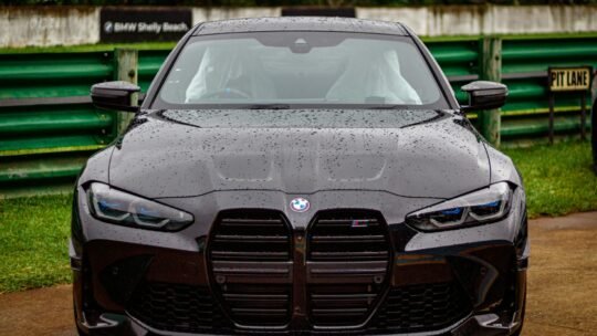 A black BMW M3 CS parked on a rainy day at a race track in Durban, South Africa.