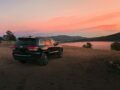 Black Jeep Grand Cherokee overlooking a scenic lake during sunset in Colorado Springs.