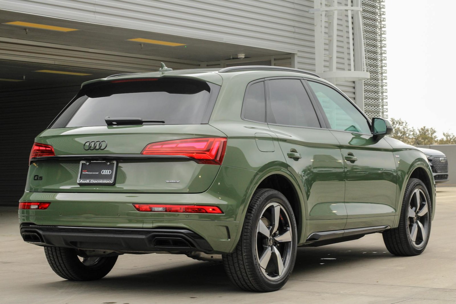 A sleek green Audi Q5 SUV parked in an urban environment showcasing modern design.