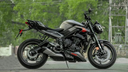 Side view of a sleek sports motorcycle parked on a street in India.