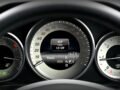 Close-up image of a car dashboard highlighting speedometer, odometer, and temperature gauge.