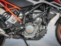 Detailed view of a KTM motorcycle engine showcasing design and machinery outdoors.