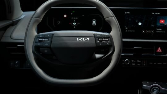 Close-up view of the Kia EV's steering wheel showcasing its modern design and technology.