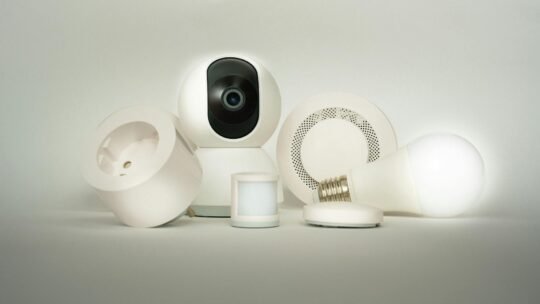 A collection of smart home devices, including a camera, light bulb, and sensors, on display.