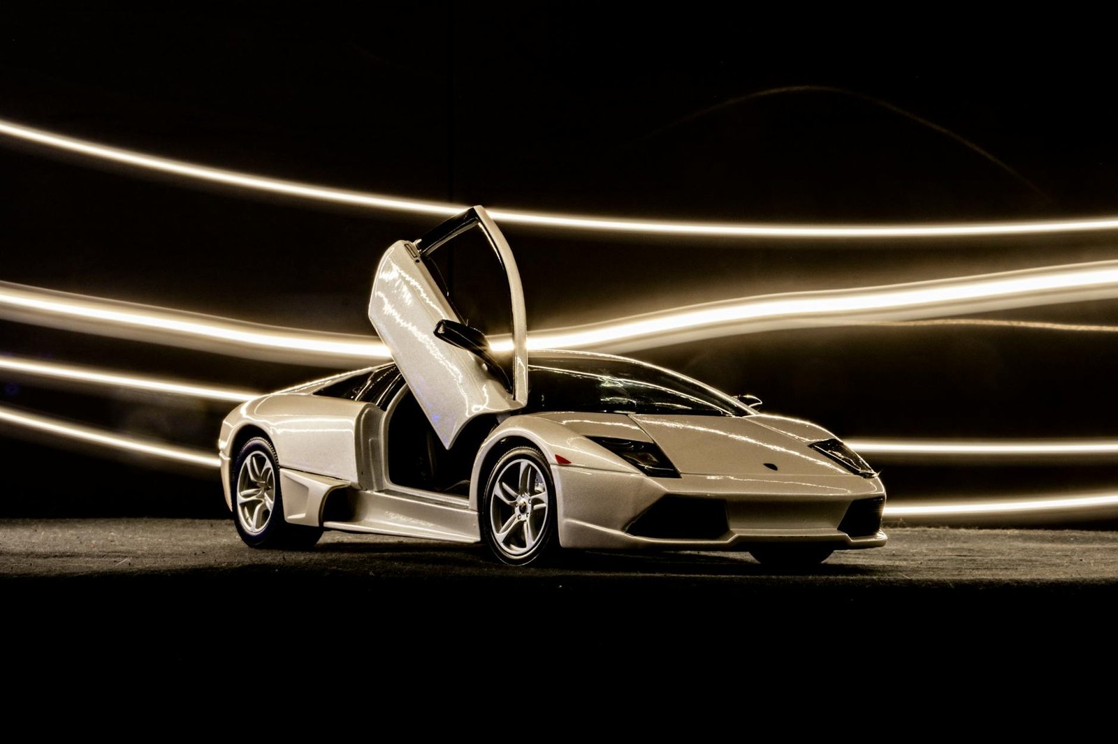 Stunning white Lamborghini Murcielago with scissor doors open, showcasing elegance and power.