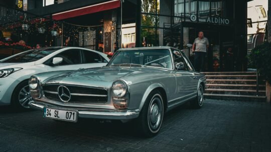 A vintage Mercedes-Benz car parked outside Hotel Aldino in Ankara, Türkiye during the day.