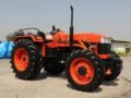 A bright orange ACE DI 65 4WD tractor showcased outdoors in Faridabad, India.