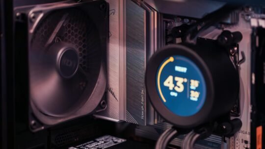 Close-up of a gaming PC build showcasing GPU, fan, and liquid cooling system.