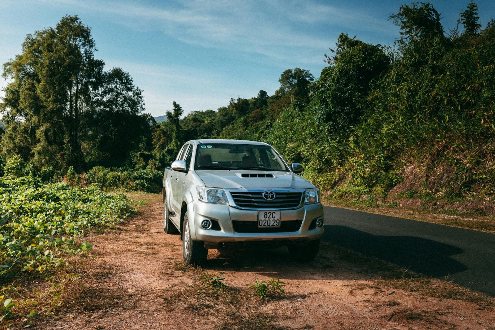 Explore Vietnam's rustic charm with an off-road vehicle amidst lush greenery in Kon Tum.