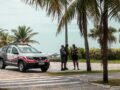 Police officers on duty near the beach with palm trees in Brazil.