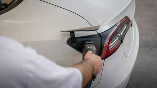 Close-up of an electric car being charged, emphasizing modern sustainable technology.