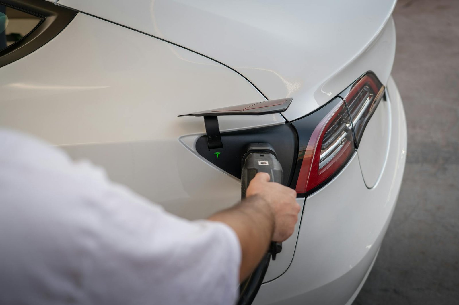 Close-up of an electric car being charged, emphasizing modern sustainable technology.