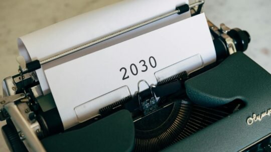 Close-up of a vintage typewriter with the year 2030 typed on paper symbolizing future concepts.