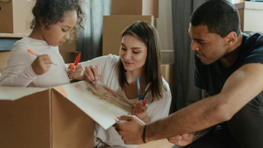 Family enjoying a creative moment while moving into a new home.