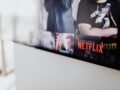 Selective focus of a Netflix screen on a smart TV in an indoor setting.