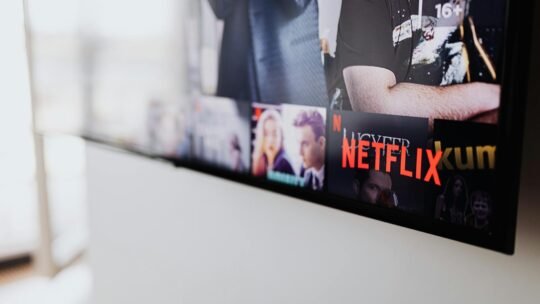 Selective focus of a Netflix screen on a smart TV in an indoor setting.