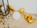 Decorative balloons and confetti on the floor, perfect for celebrations and New Year parties.